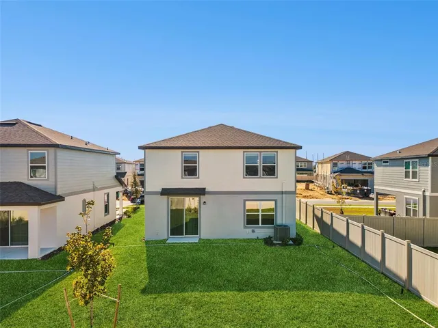 a view of house with a yard