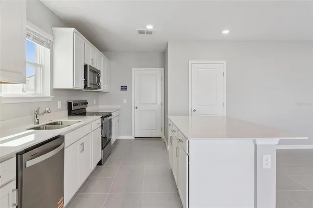 a kitchen with white cabinets