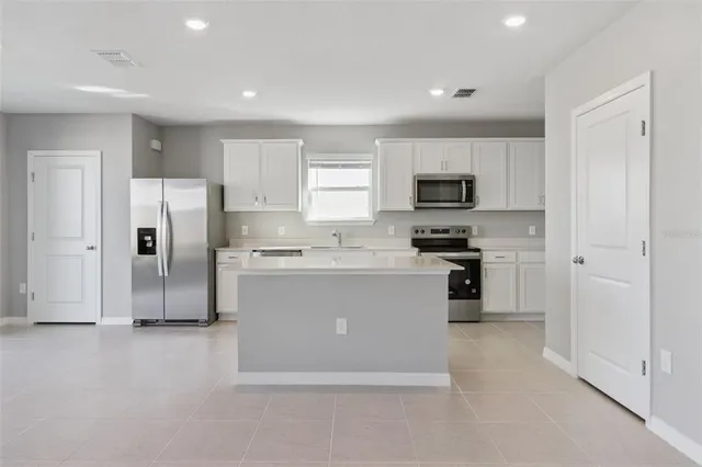 a kitchen with a refrigerator stove and microwave
