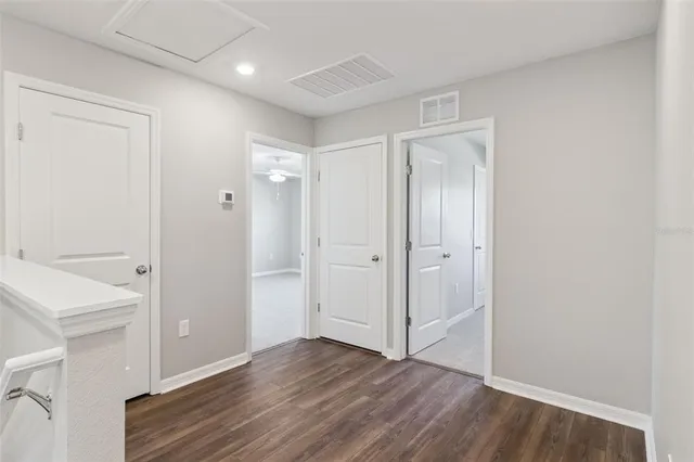 a view of an empty room and wooden floor