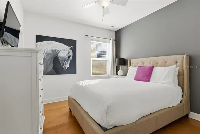 a bedroom with a large bed and a flat screen tv