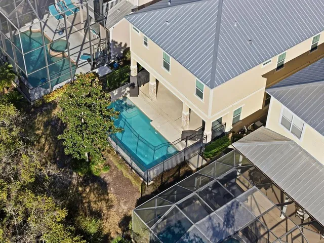 an aerial view of residential houses with wooden fence