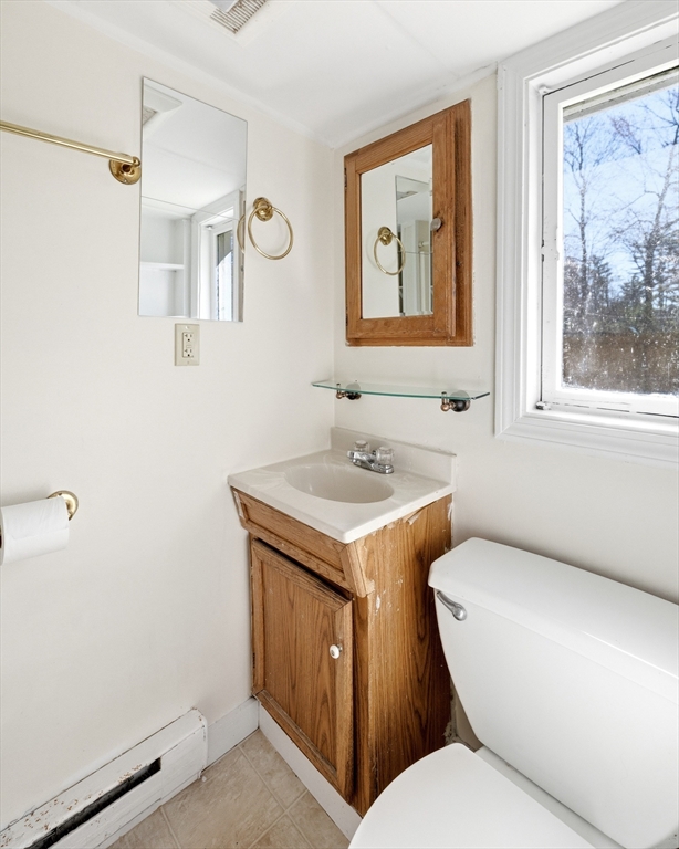 133 Lakeview Road Shutesbury, MA 01072 - Photo 10 of 24 a bathroom with a toilet sink and mirror
