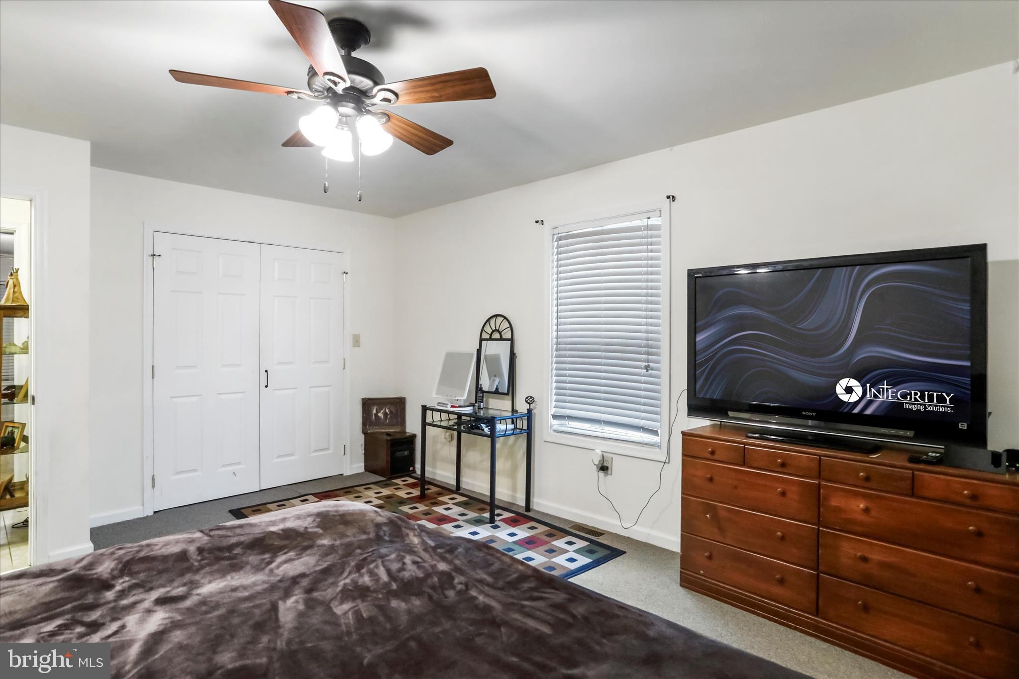 12542 Turkey Farm Road Northeast Little Orleans, MD 21766 - Photo 27 of 77 a bedroom with a bed and a flat tv screen on the dresser