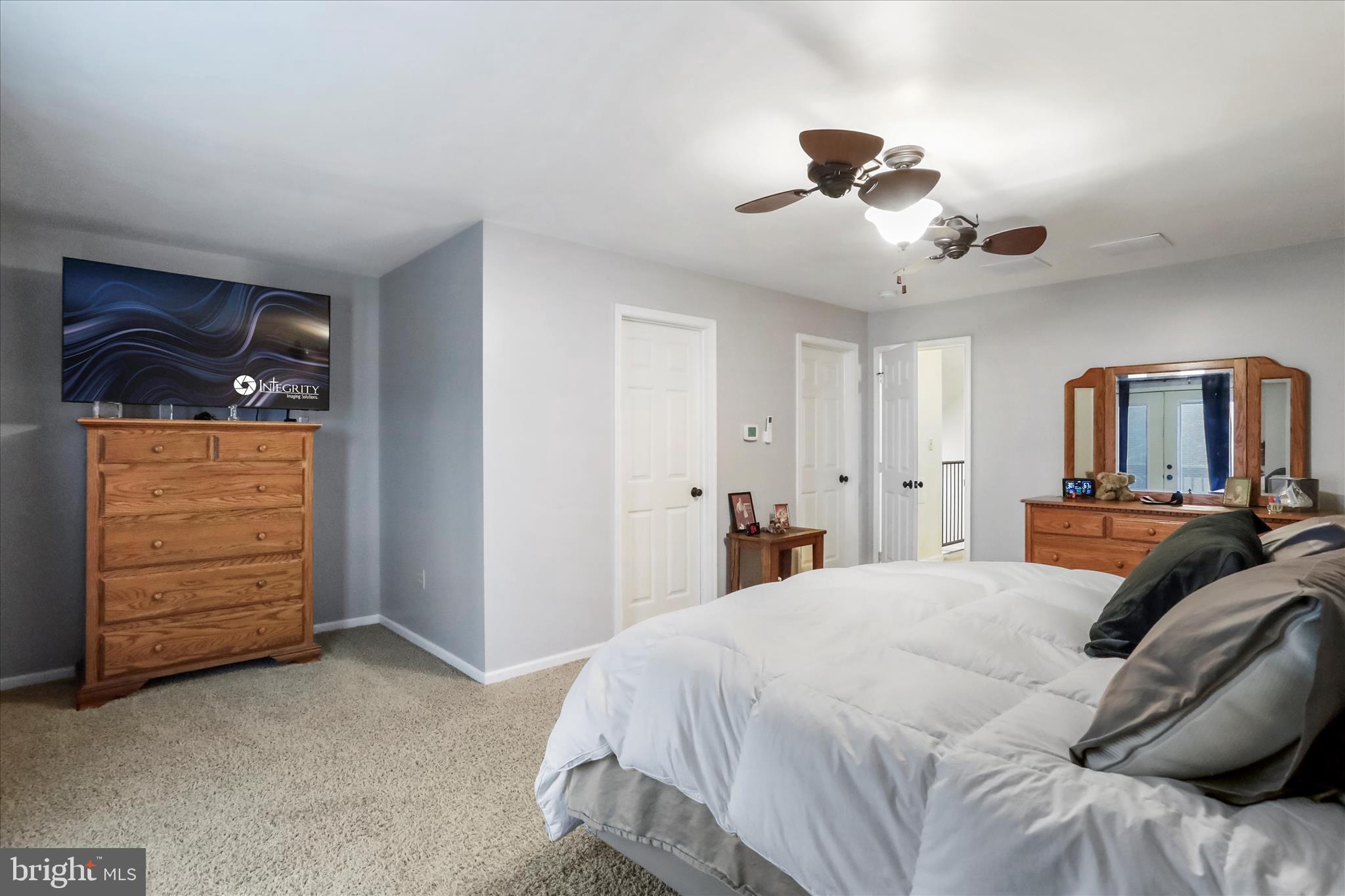 12542 Turkey Farm Road Northeast Little Orleans, MD 21766 - Photo 30 of 77 a bedroom with a large bed and a ceiling fan