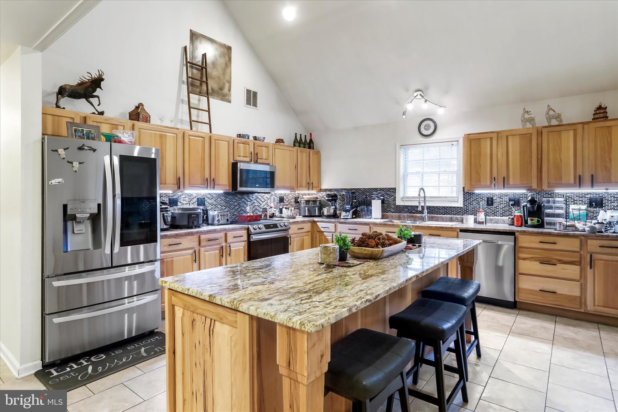 12542 Turkey Farm Road Northeast Little Orleans, MD 21766 - Photo 6 of 77 a kitchen with granite countertop a refrigerator a stove and a sink