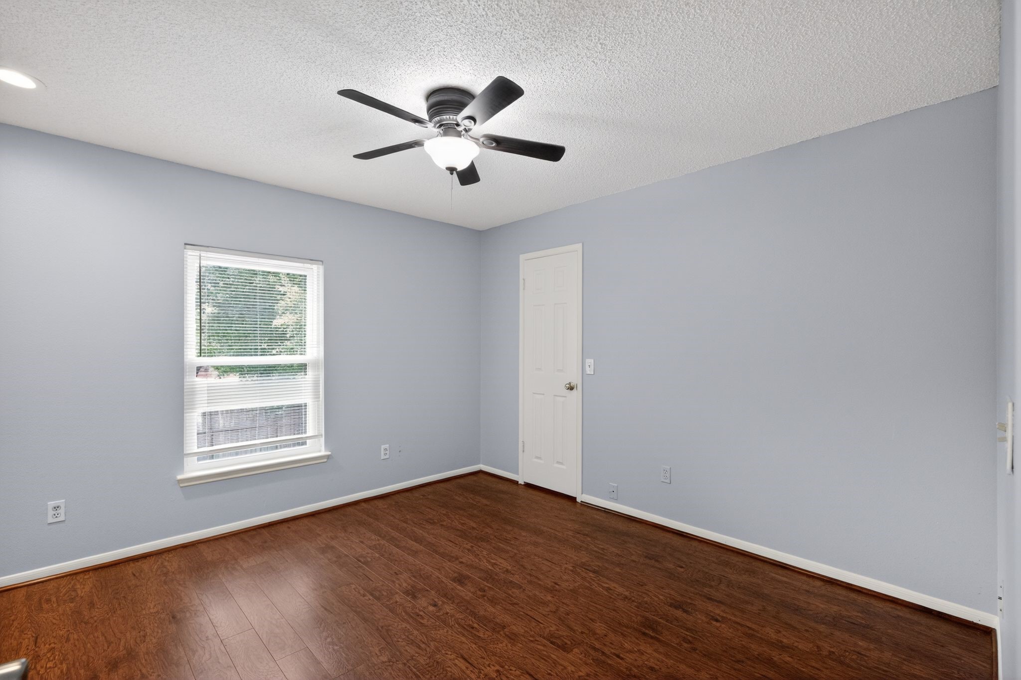 918 Long Prairie Drive Katy, TX 77450 - Photo 11 of 30 a view of empty room with wooden floor and fan