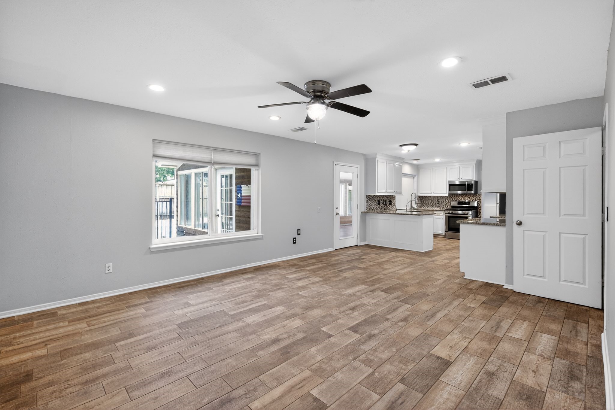 918 Long Prairie Drive Katy, TX 77450 - Photo 12 of 30 a view of an empty room with kitchen appliances and a window