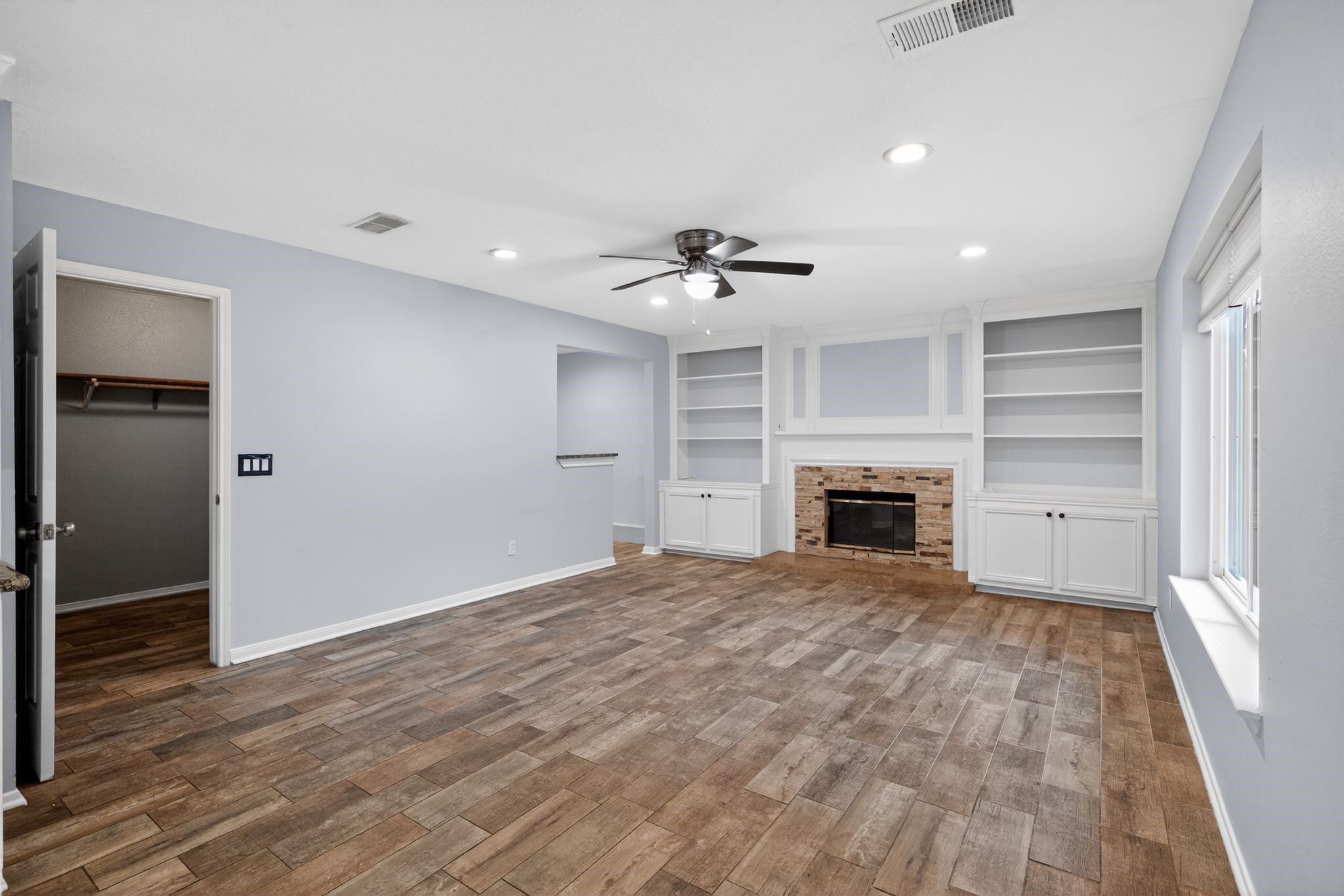 918 Long Prairie Drive Katy, TX 77450 - Photo 14 of 30 a view of an empty room with a fireplace and a window