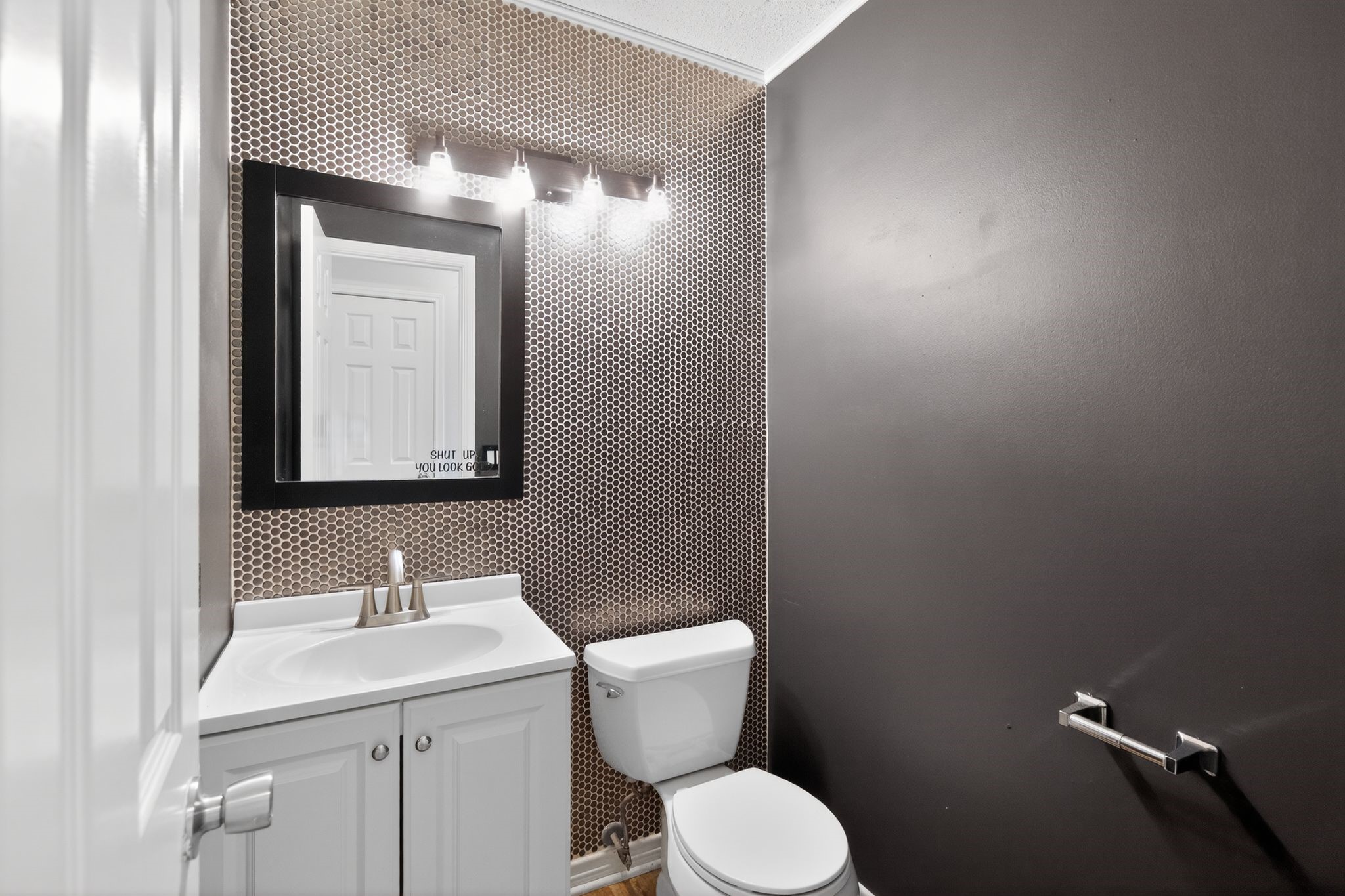 918 Long Prairie Drive Katy, TX 77450 - Photo 25 of 30 a bathroom with a toilet a sink and mirror