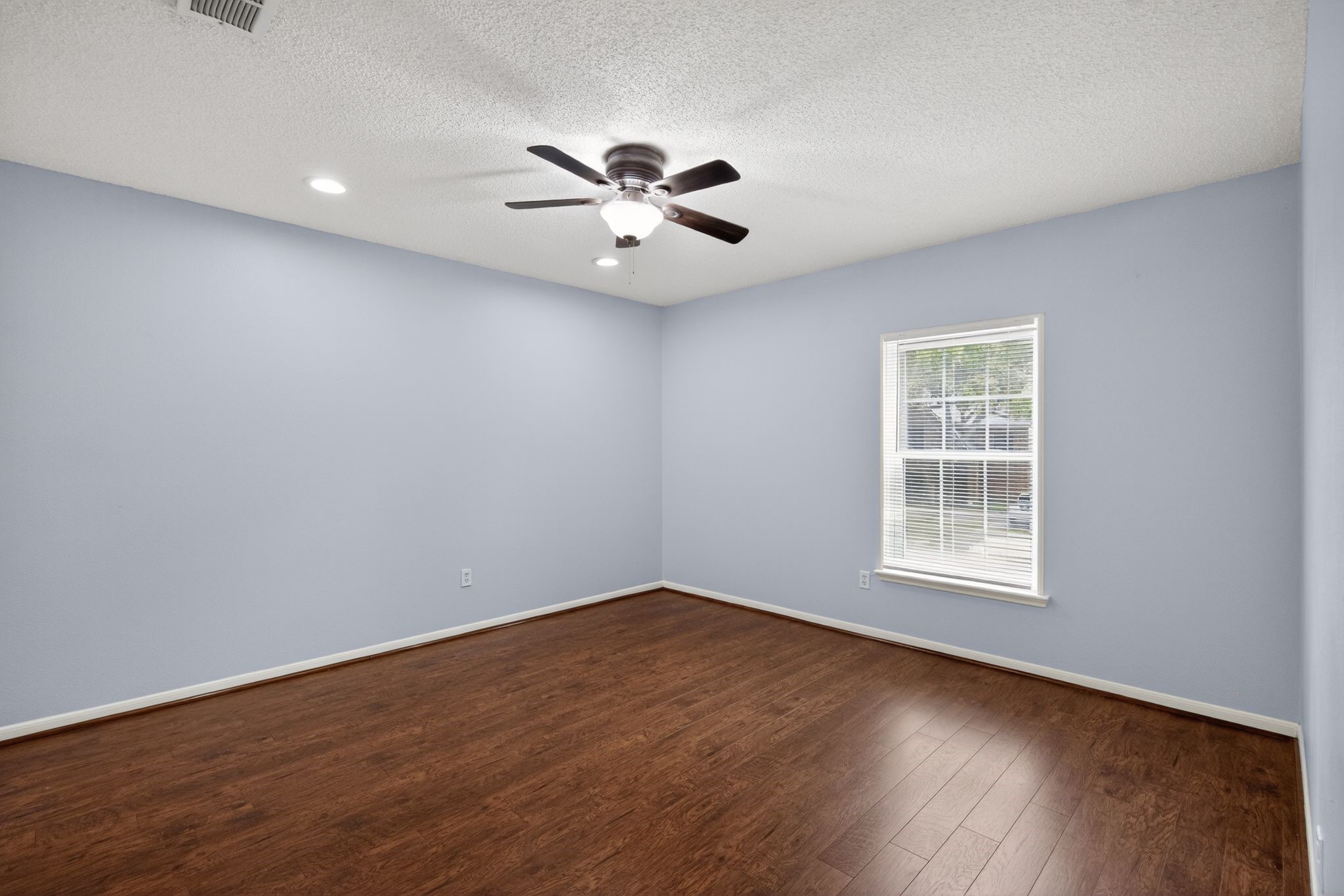 918 Long Prairie Drive Katy, TX 77450 - Photo 10 of 30 wooden floor in an empty room with a window