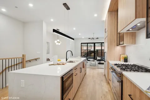 a open kitchen with stainless steel appliances kitchen island granite countertop a sink and cabinets