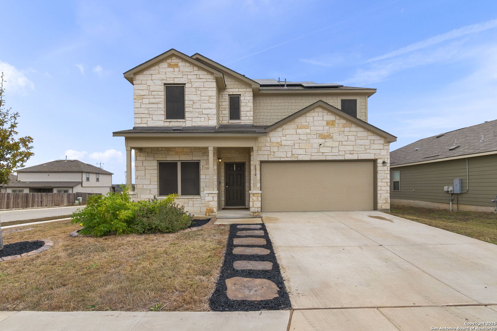 a front view of a house with a yard and garage