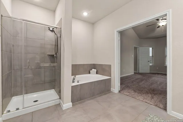 a bathroom with a tub shower and sink
