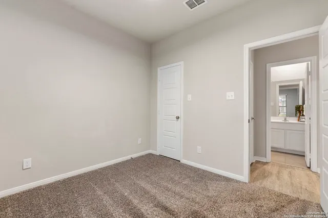 a view of an empty room and closet