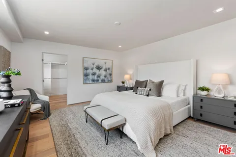 a bedroom with a bed and a lamp on table