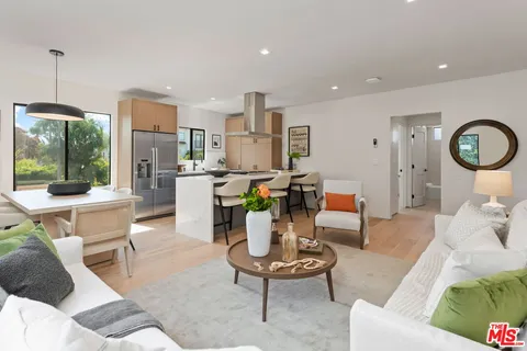 a living room with furniture a window and kitchen view