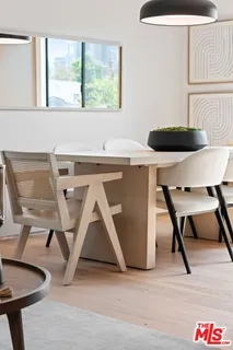 a living room with a table and a chair