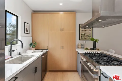 a kitchen with a sink stove and refrigerator