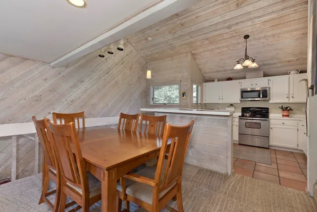 a kitchen with stainless steel appliances granite countertop a sink a stove and refrigerator