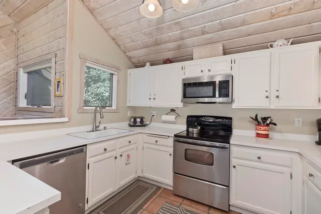 a kitchen with a sink cabinets and window