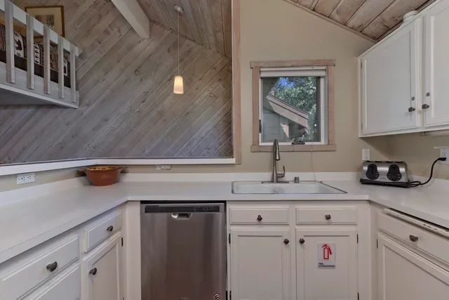 a kitchen with a refrigerator and cabinets
