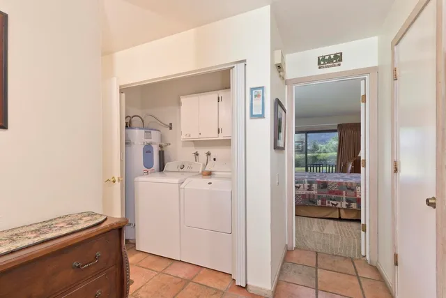 a kitchen with white cabinets and counter space