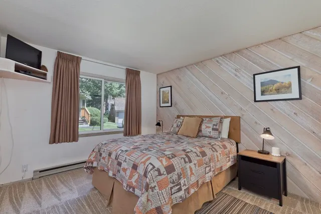 a bedroom with a large bed and a window