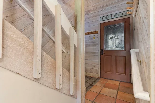 a living room with furniture large window and flat screen tv