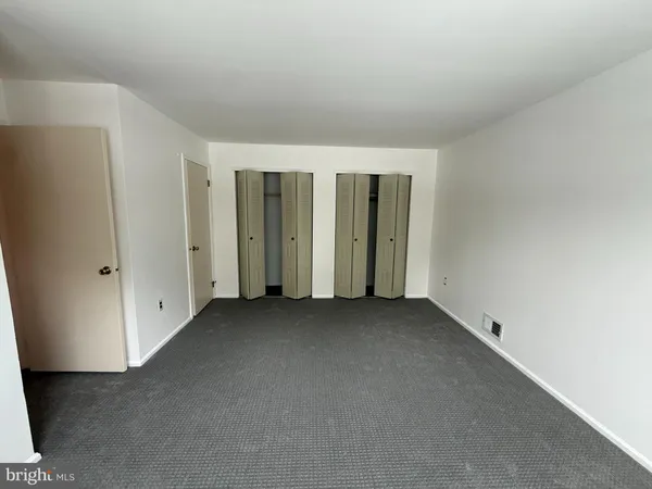 an empty room with a empty space and windows