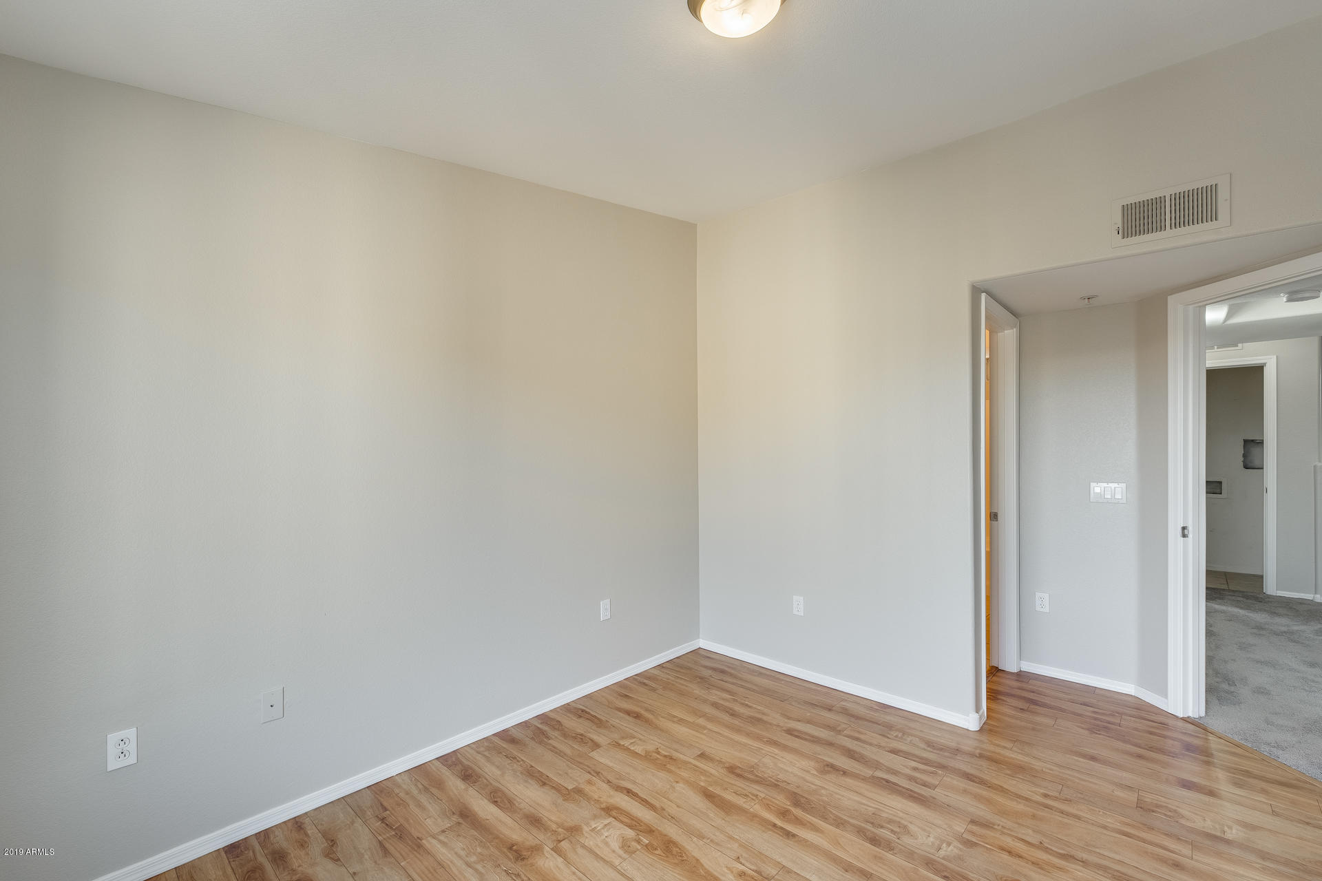 2401 East Rio Salado Parkway, Unit 1124 Tempe, AZ 85288 - Photo 29 of 32 a view of an empty room with wooden floor and closet