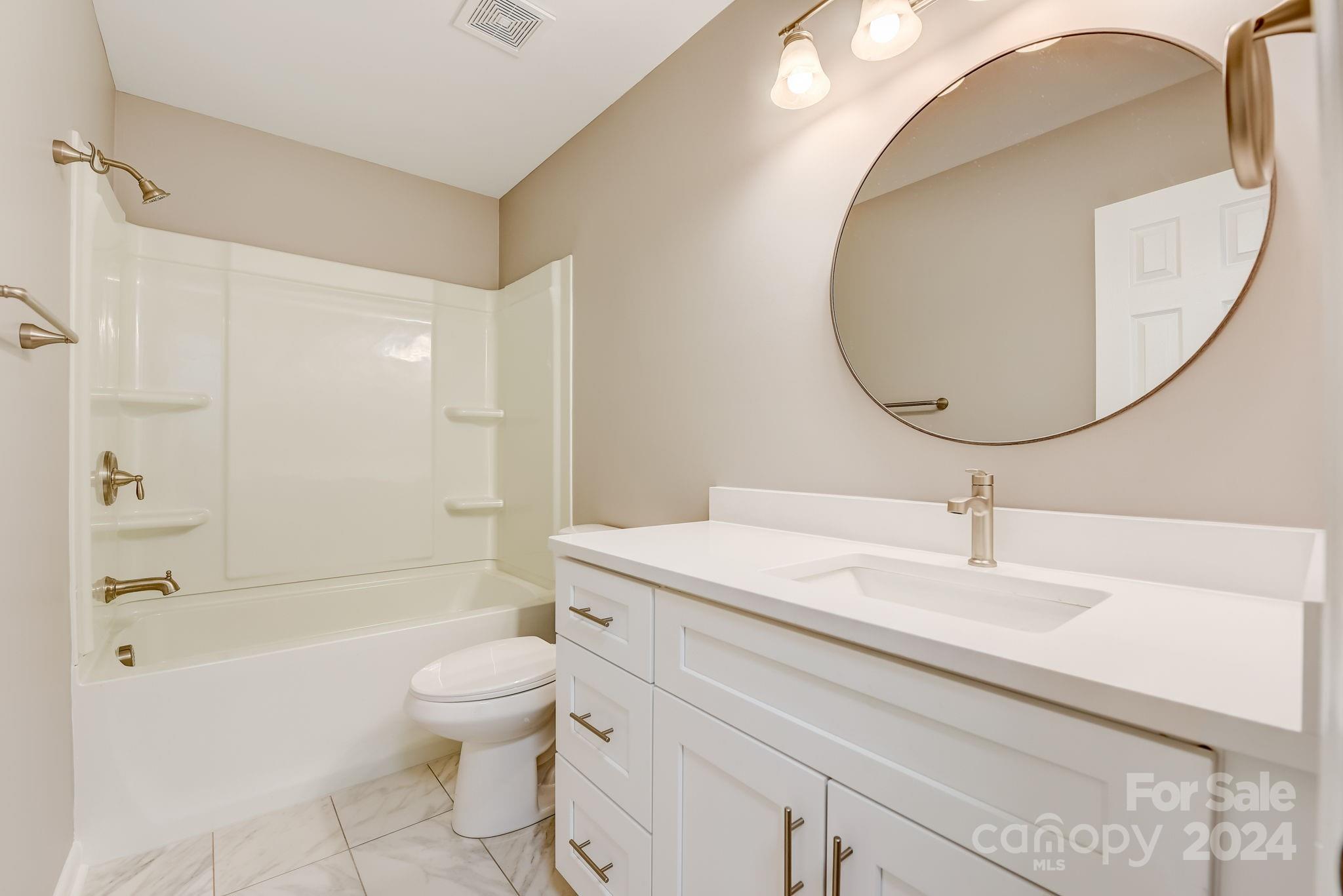 16218 Barbee Road Stanfield, NC 28163 - Photo 18 of 48 a bathroom with a sink a toilet and a mirror