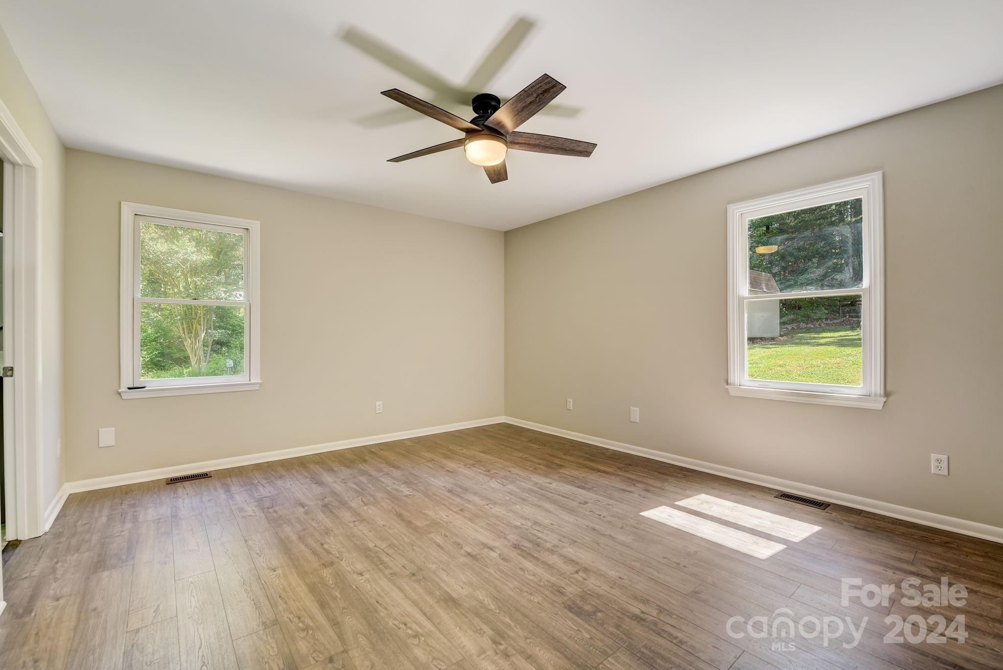 16218 Barbee Road Stanfield, NC 28163 - Photo 21 of 48 wooden floor in an empty room with a window