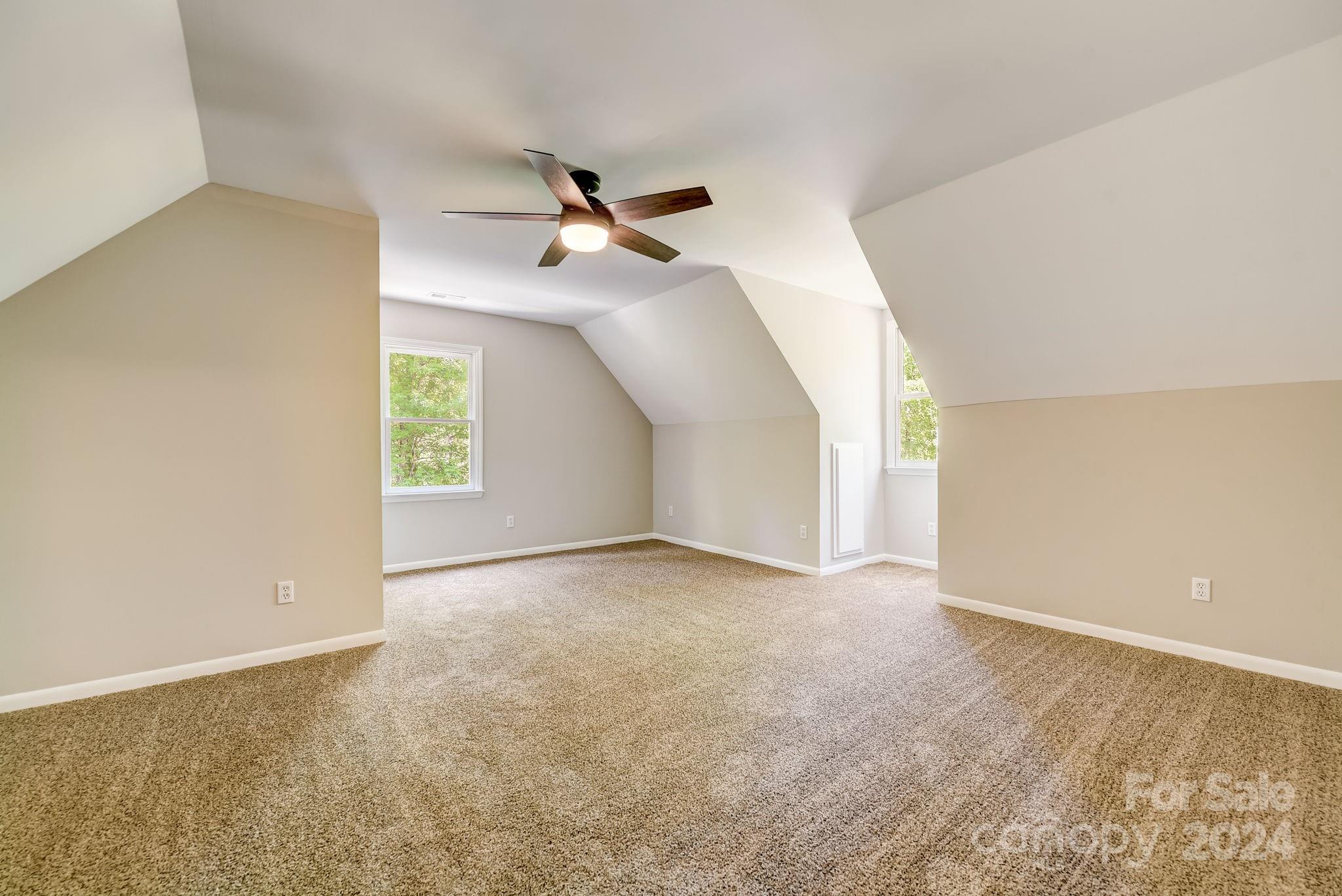 16218 Barbee Road Stanfield, NC 28163 - Photo 27 of 48 an empty room with a ceiling fan and window