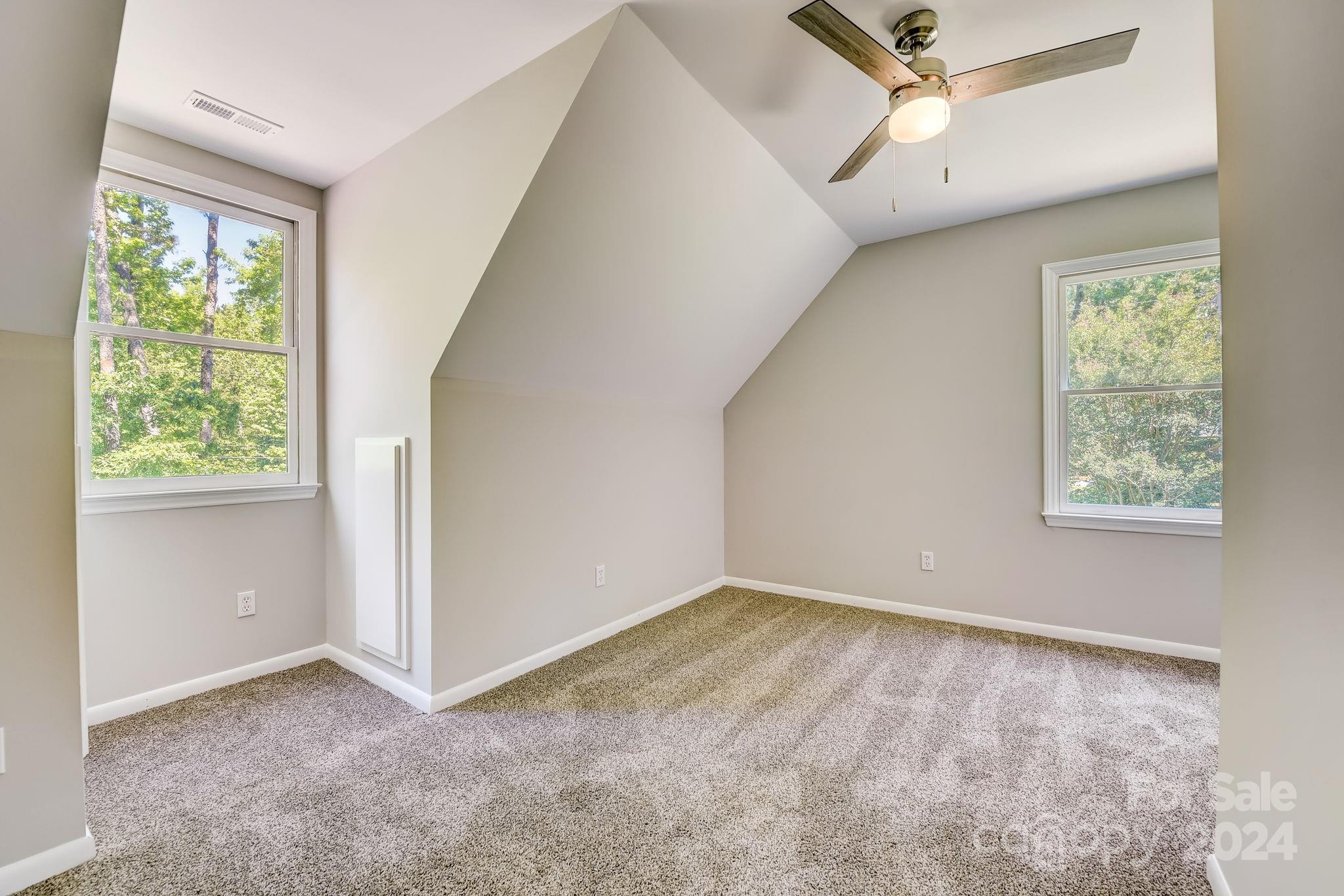 16218 Barbee Road Stanfield, NC 28163 - Photo 29 of 48 an empty room with a window and a fan