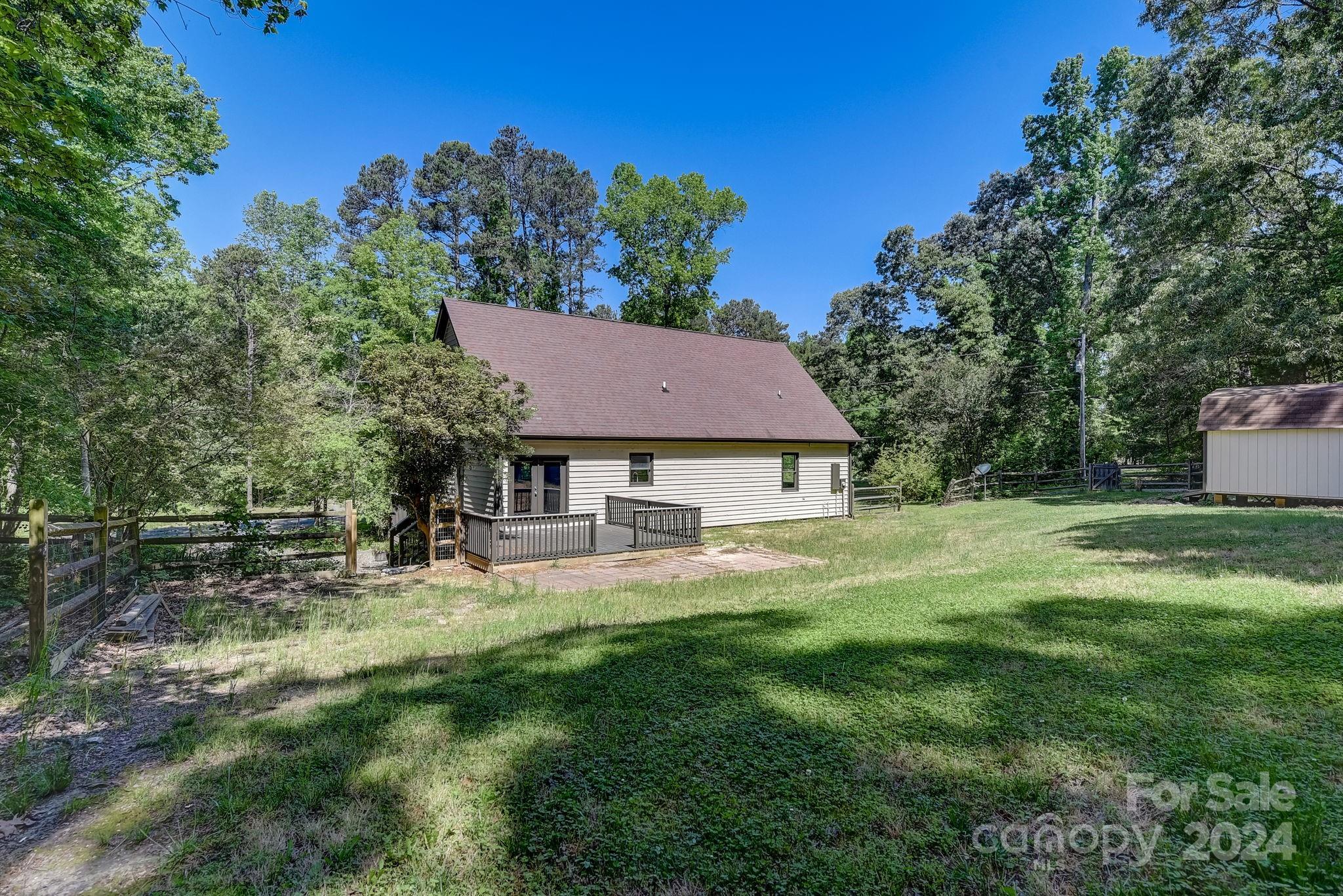 16218 Barbee Road Stanfield, NC 28163 - Photo 37 of 48 a view of a house with a yard potted plants and large tree