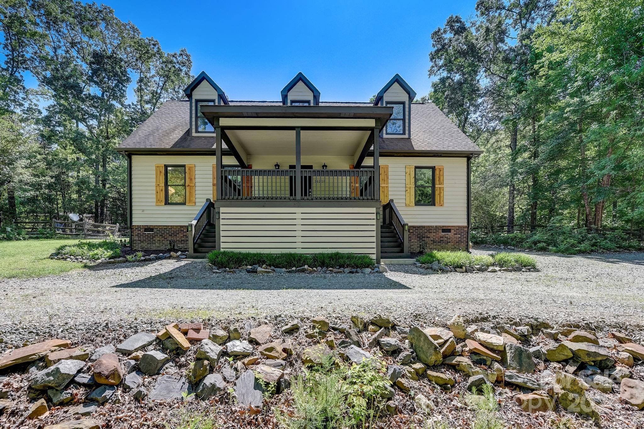 16218 Barbee Road Stanfield, NC 28163 - Photo 44 of 48 a front view of a house with a garden