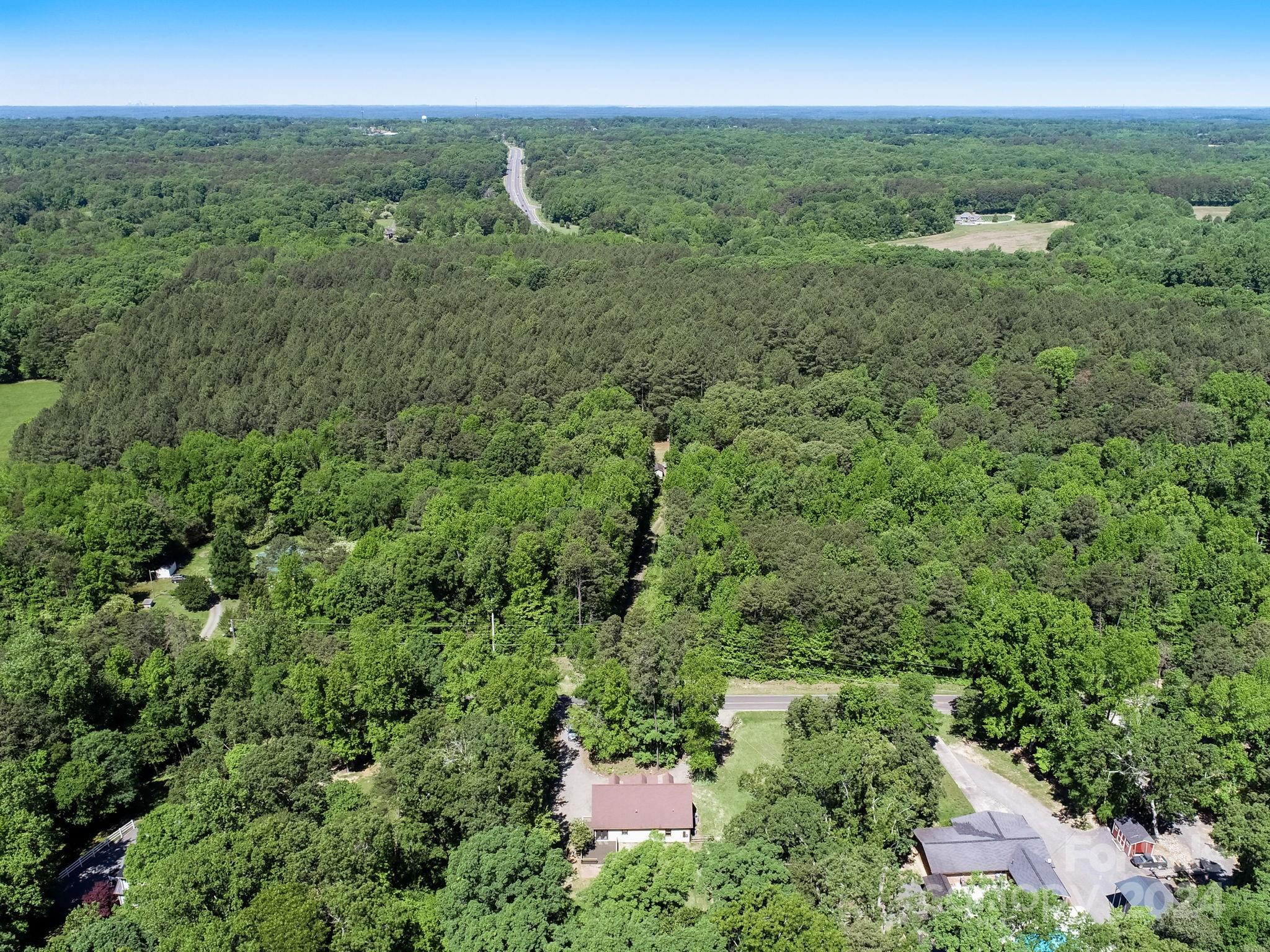 16218 Barbee Road Stanfield, NC 28163 - Photo 46 of 48 a view of a city with lush green forest