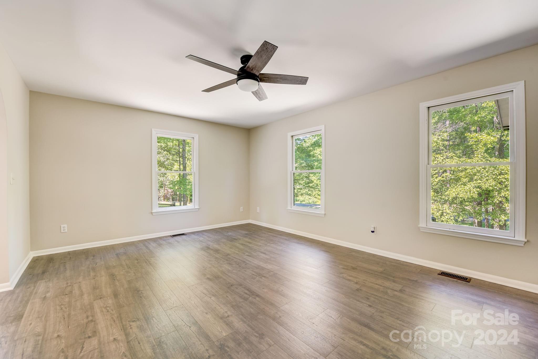 16218 Barbee Road Stanfield, NC 28163 - Photo 8 of 48 a view of an empty room with wooden floor and a window