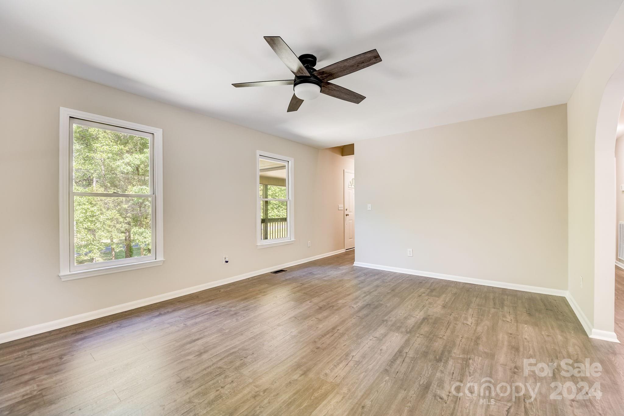 16218 Barbee Road Stanfield, NC 28163 - Photo 9 of 48 wooden floor in an empty room with a window