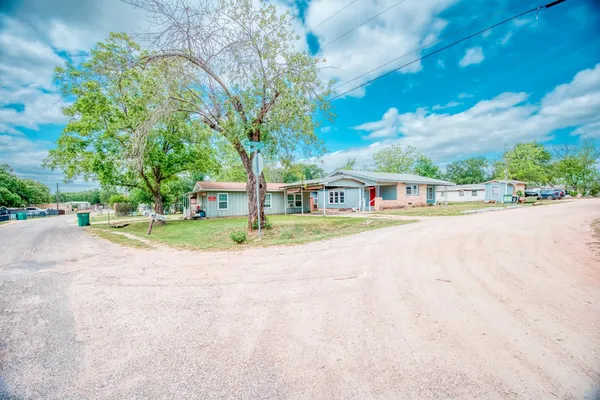 a view of house with outdoor space and tree s