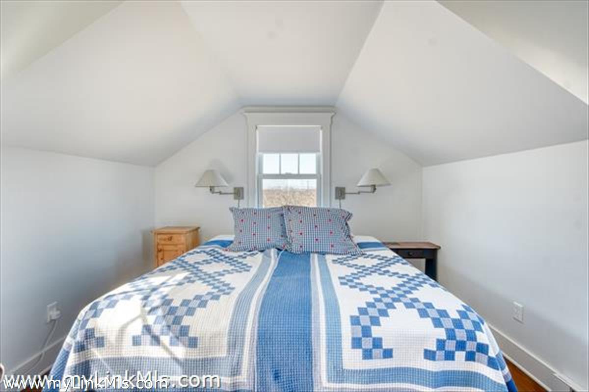 100 Baxter Road Nantucket, MA 02554 - Photo 9 of 11 a bedroom with a bed and wooden floor