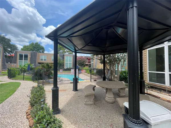 a view of a porch with chairs and backyard