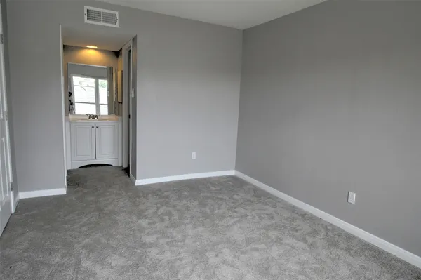 a view of an empty room and closet area