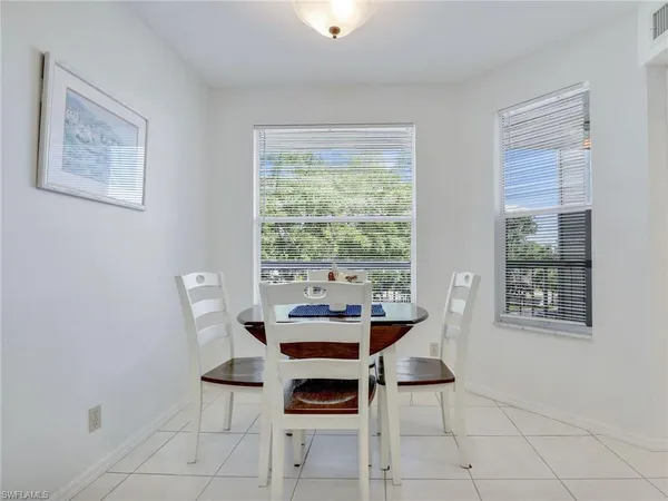 a dining room with furniture and window