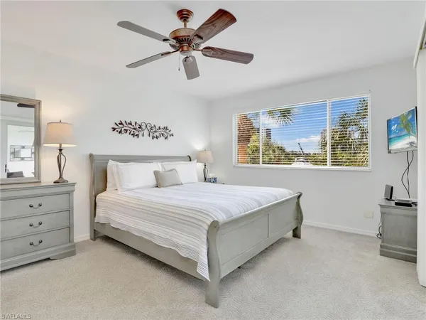 a bedroom with a large bed and a chandelier