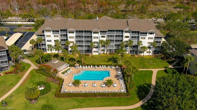 an aerial view of residential houses with outdoor space and swimming pool