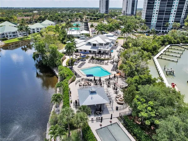 an aerial view of a house with a yard and lake view