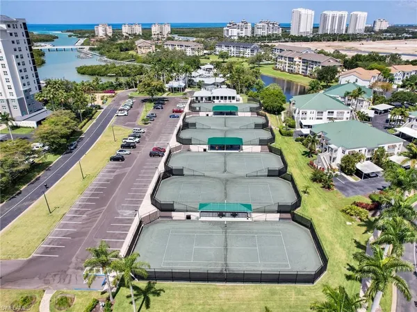 an aerial view of residential houses with outdoor space and lake view