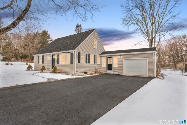 a front view of a house with a road and a yard